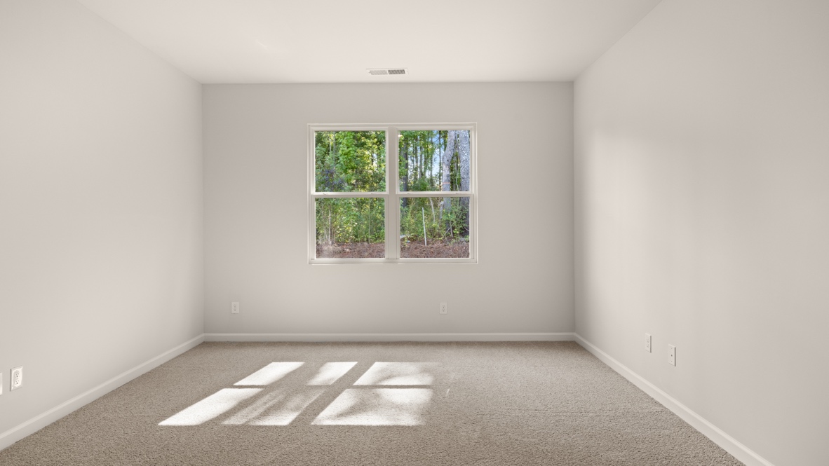 Interior primary bedroom with large window