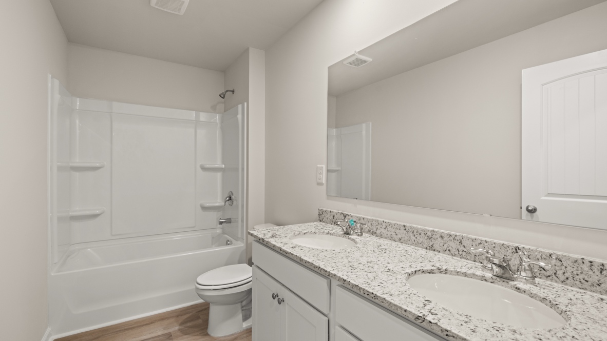 Interior bathroom with double sink and full-sized shower