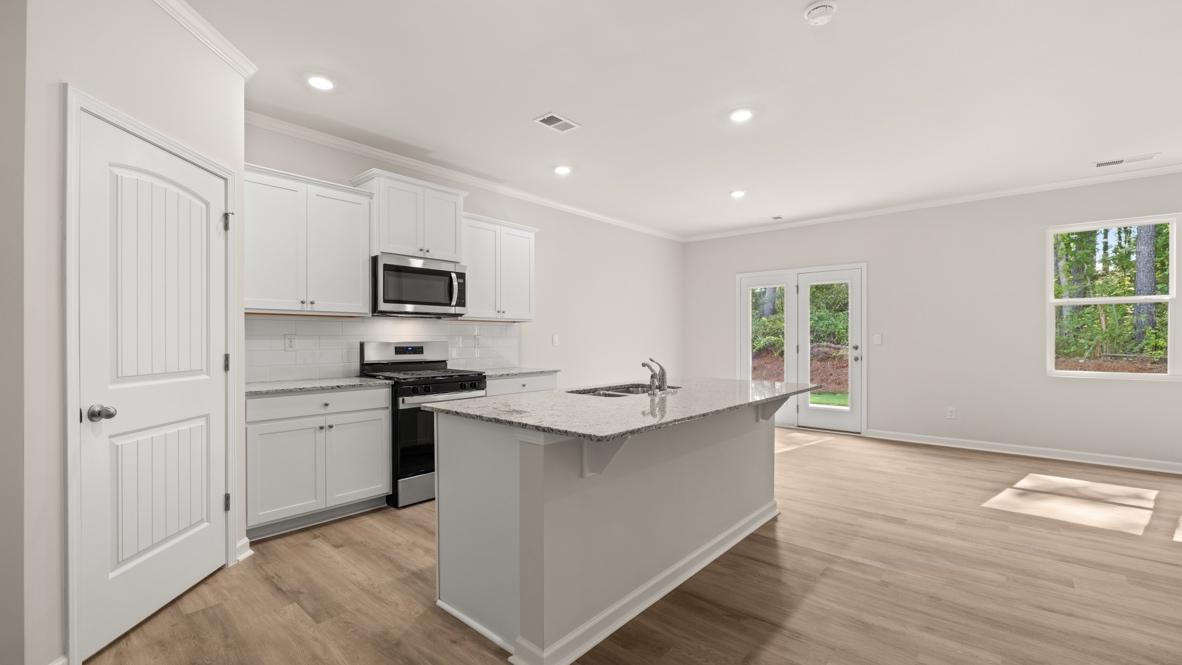 Interior kitchen with center island with white cabinets