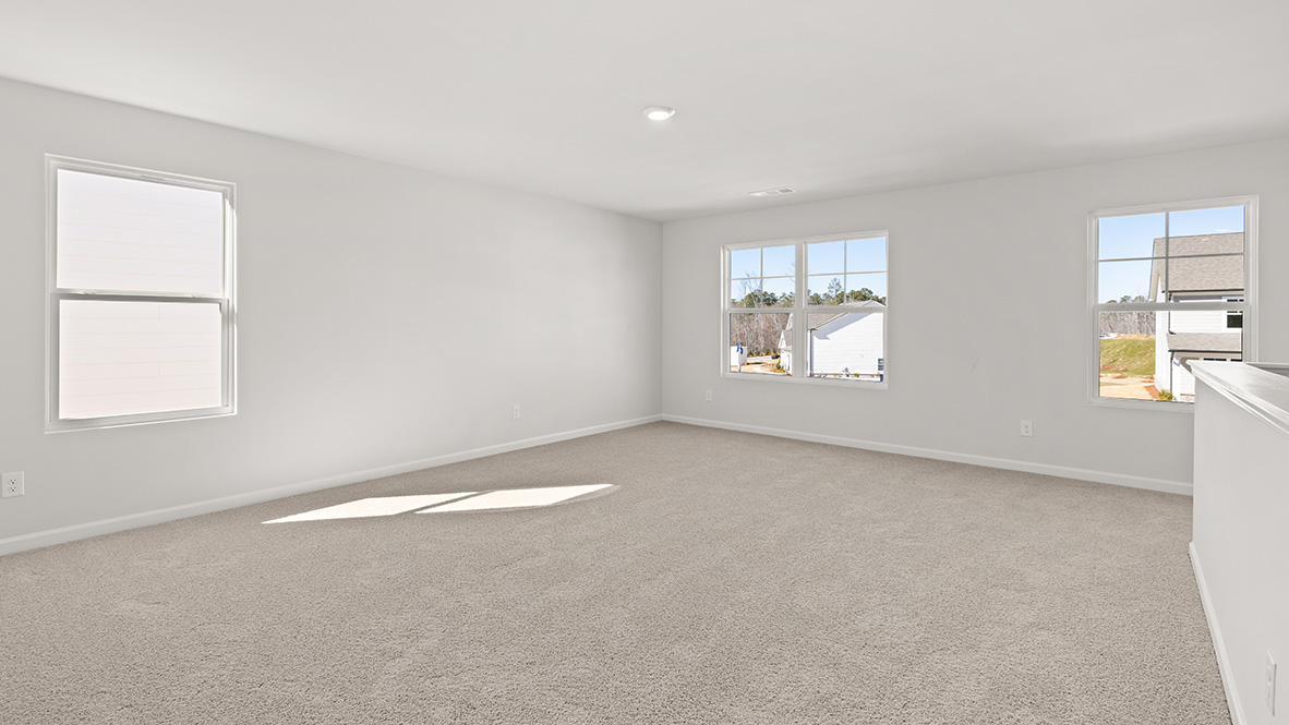 Upstairs living area with two single windows and one double window.