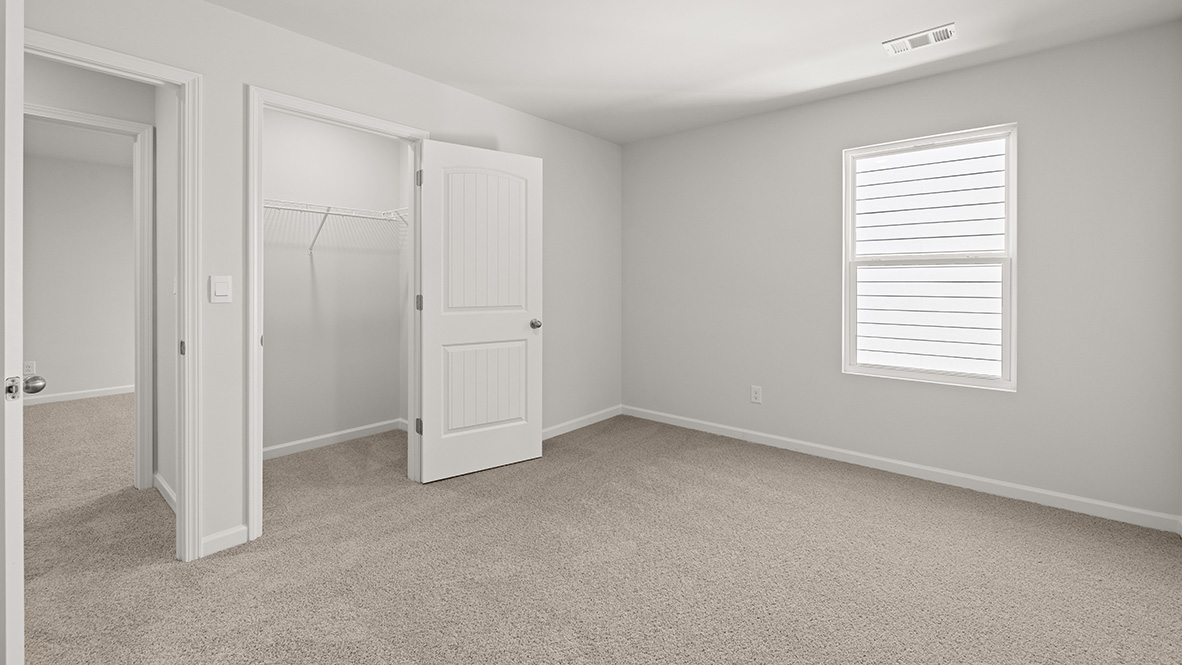 Bedroom with neutral carpet, a single window and a closet.