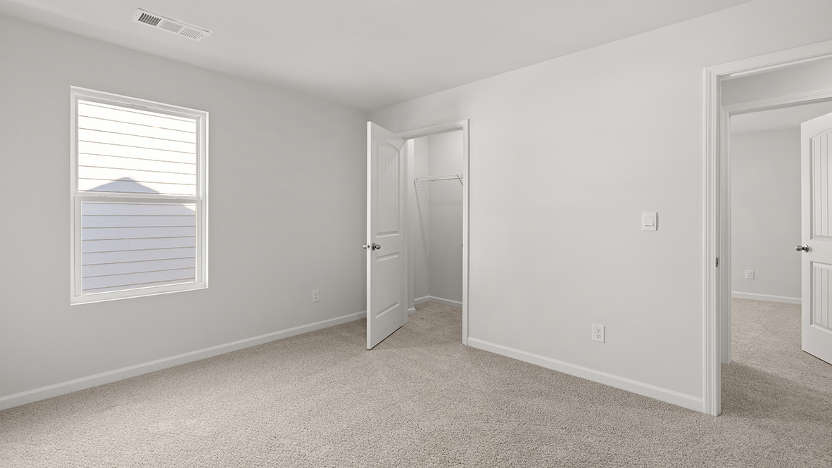 Bedroom with neutral carpet, a single window and a closet.