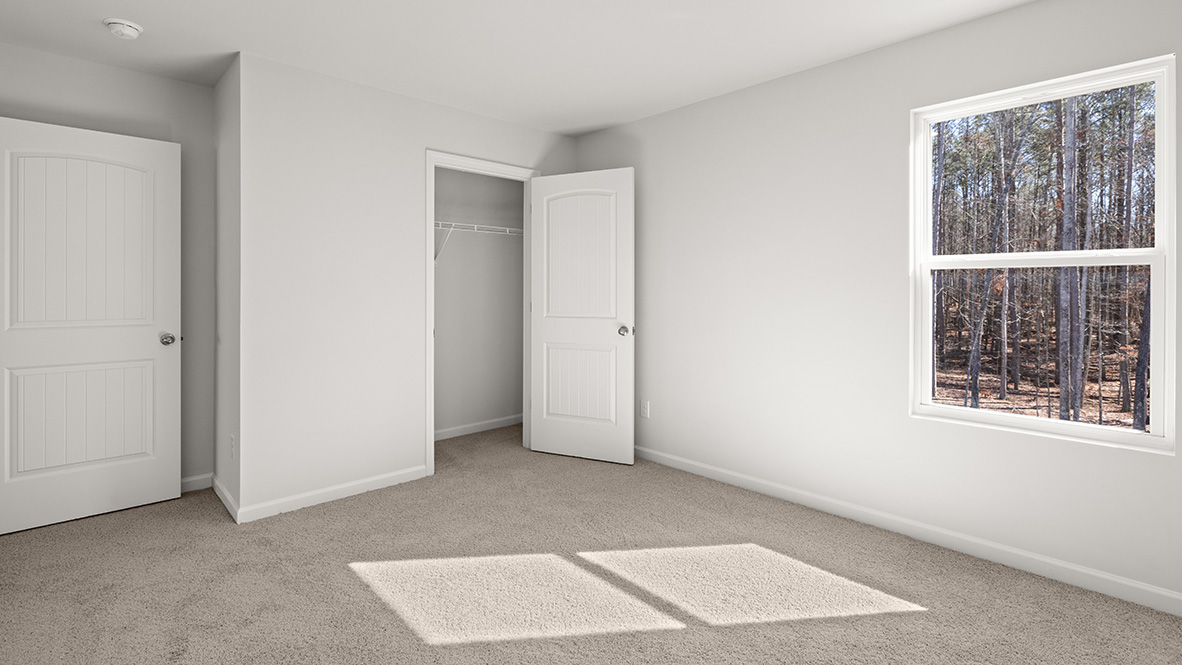Bedroom with neutral carpet, a single window and a closet.