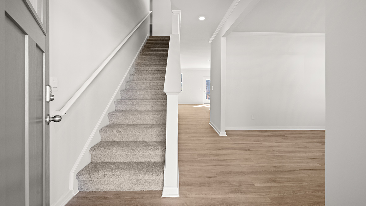 View from the front door of the entrance, the flex room, and the living room.