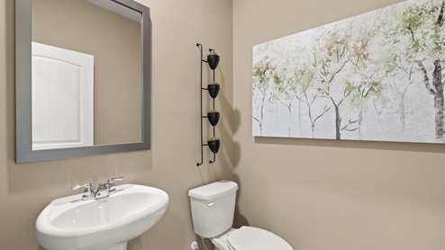 Powder bathroom with a pedestal sink and mirror
