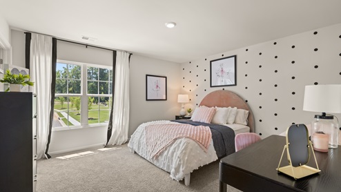 bedroom with beige carpet, white walls and a window