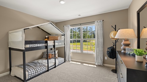 bedroom with beige carpet, beige walls and a window