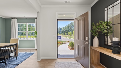front entry way of home featuring brown flooring and white walls