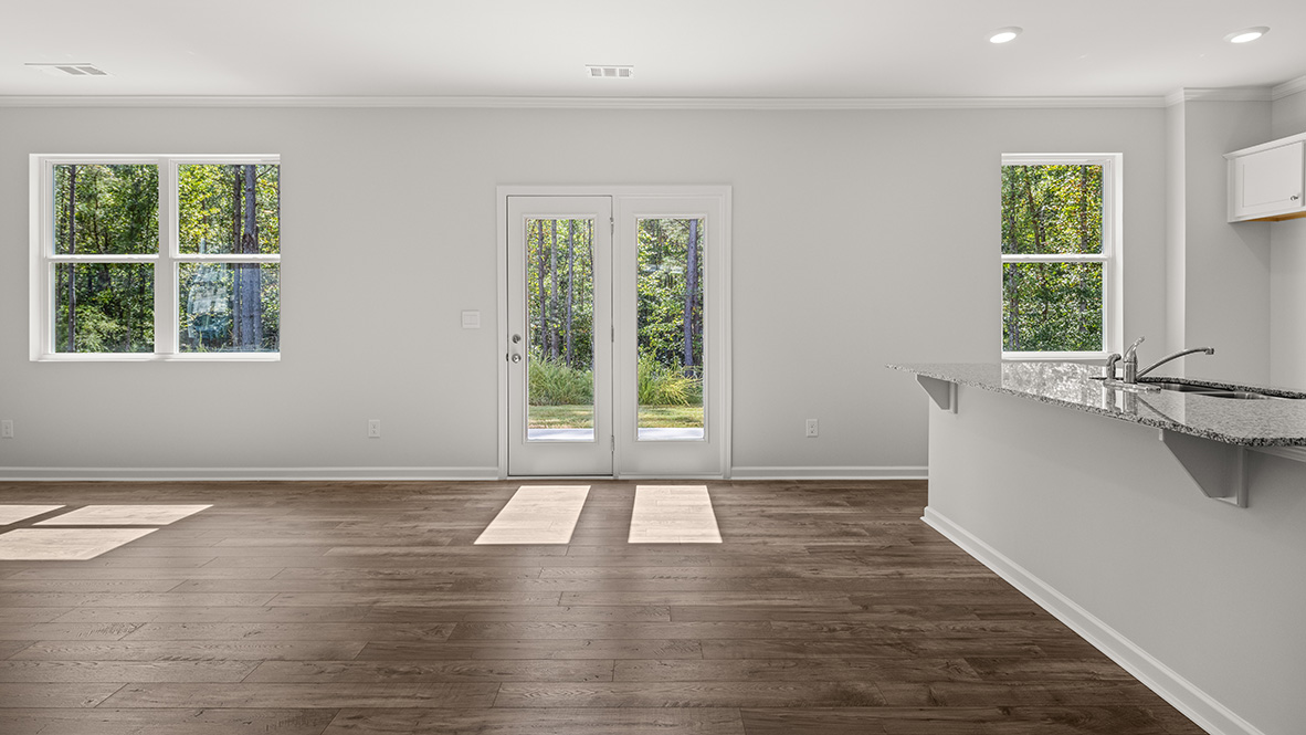 Open-concept great room living area with a view of the dining area and kitchen.