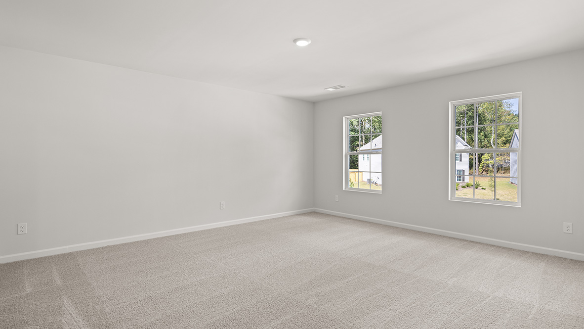 Bedroom 1 with neutral carpet and two single windows.