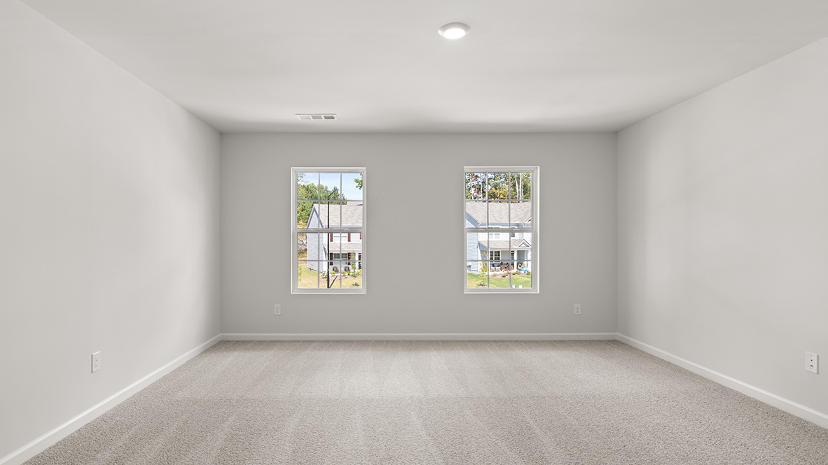 Bedroom 1 with neutral carpet and two single windows.