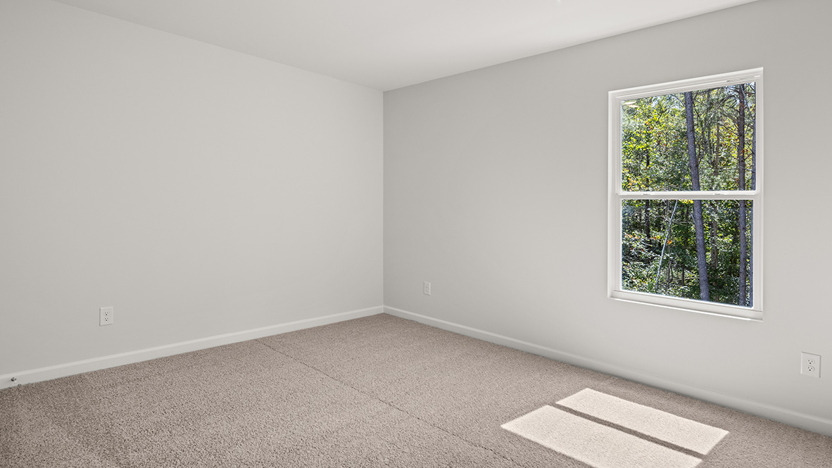Bedroom 3  with neutral carpet and a single window