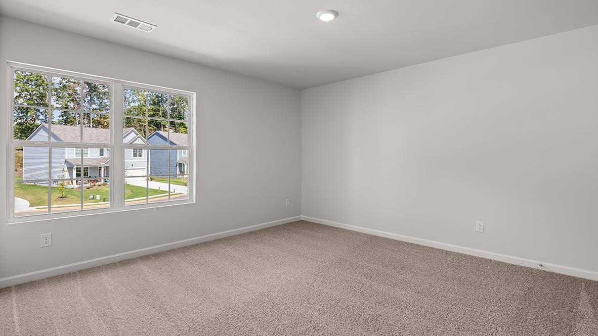 Bedroom 2 with a double window and neutral carpet.