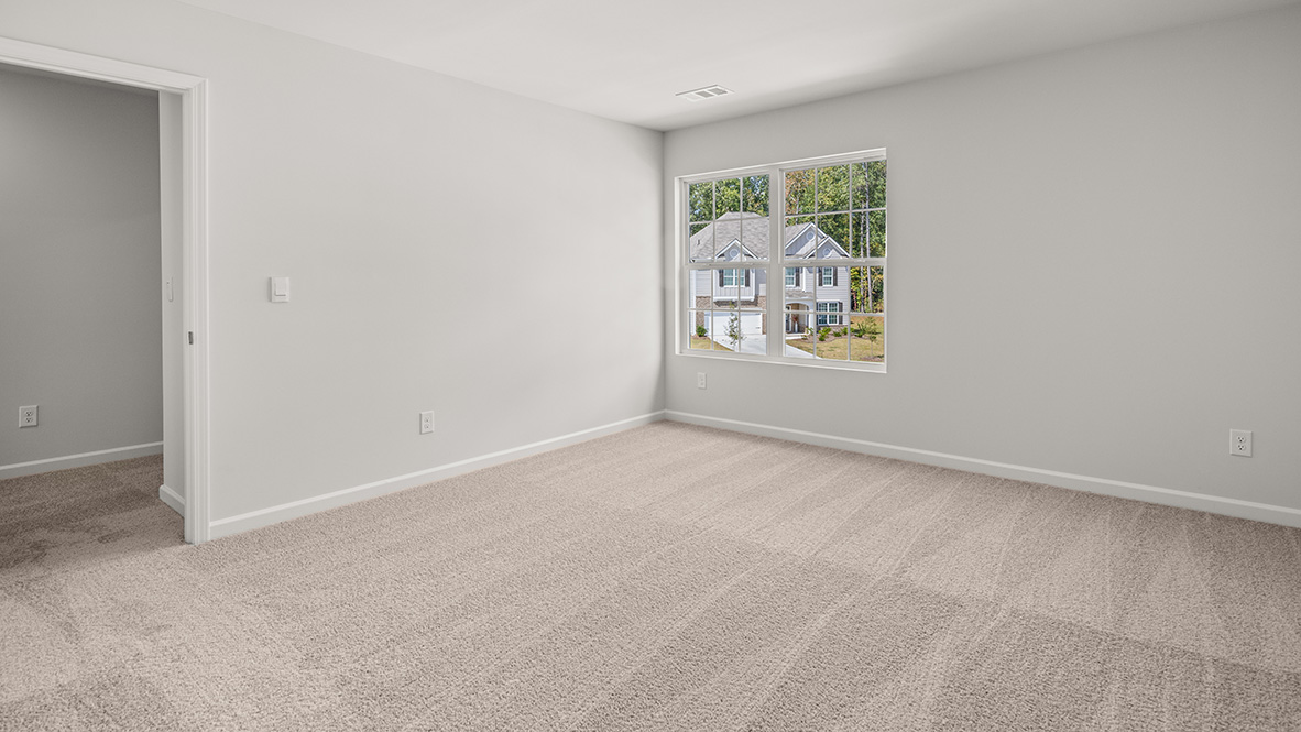 Bedroom with a double window and neutral carpet.