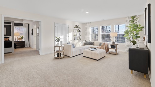 Upstairs loft area with carpeted floors.