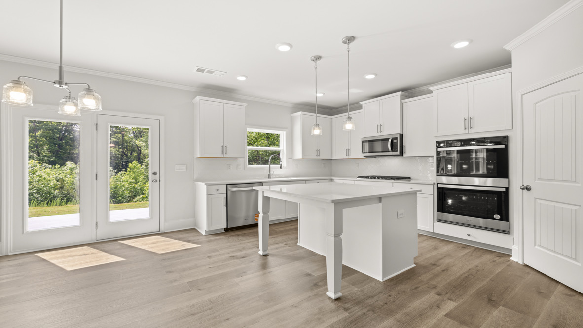 Interior kitchen with center island and white cabinets