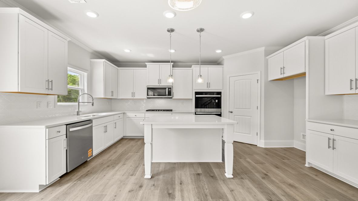 Interior kitchen with center island and white cabinets