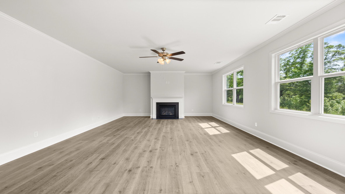 Interior living area with fire place, large windows and back patio doors