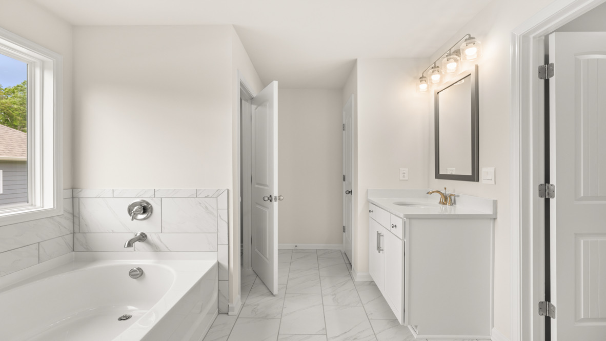 Interior primary bathroom with sink, bath tub and shower
