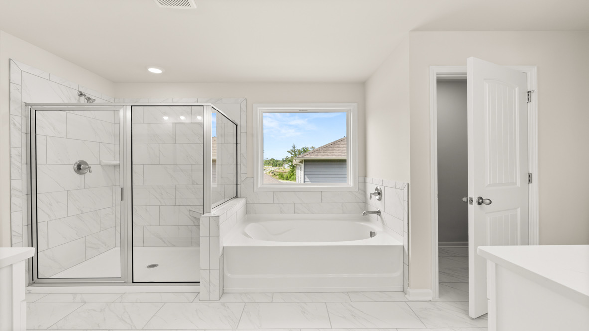 Interior primary bathroom with sink, bath tub and shower