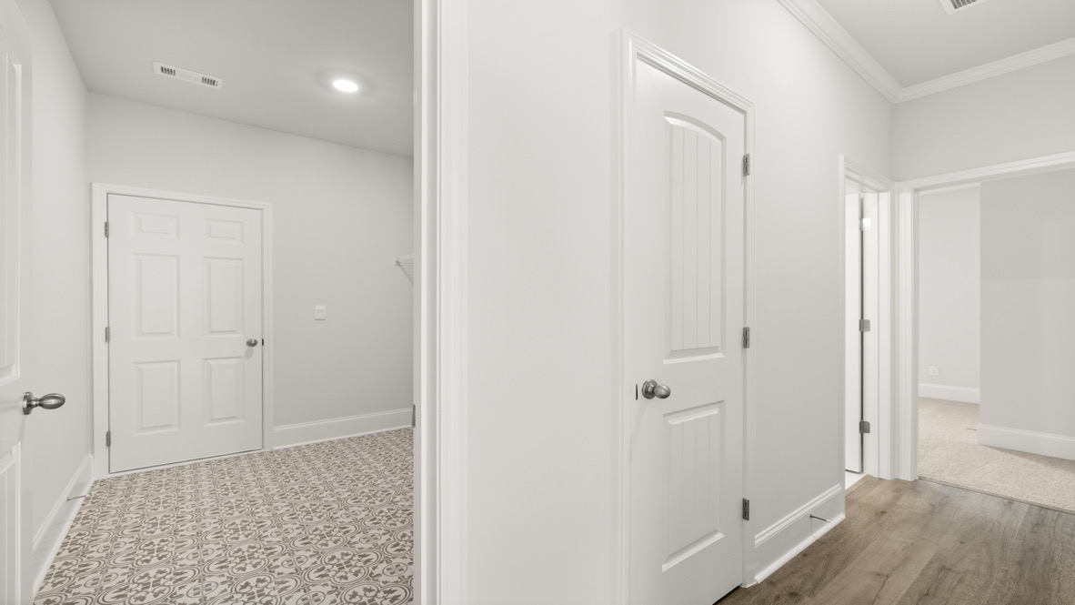 Laundry space in D.R. Horton Butner Estates home with upper storage solutions