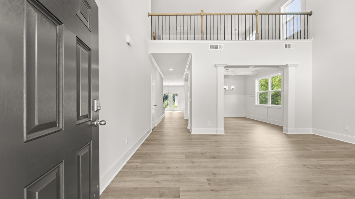 Step inside Butner Estates, Grayson Plan, see upstairs loft space and Dining Room set to natural light all through the home