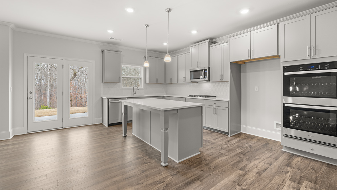 Interior kitchen with center island and light grey cabinets