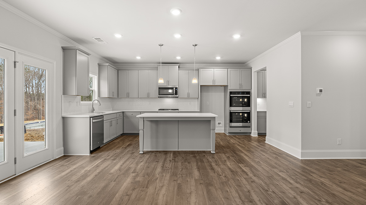 Interior kitchen with center island and light grey cabinets