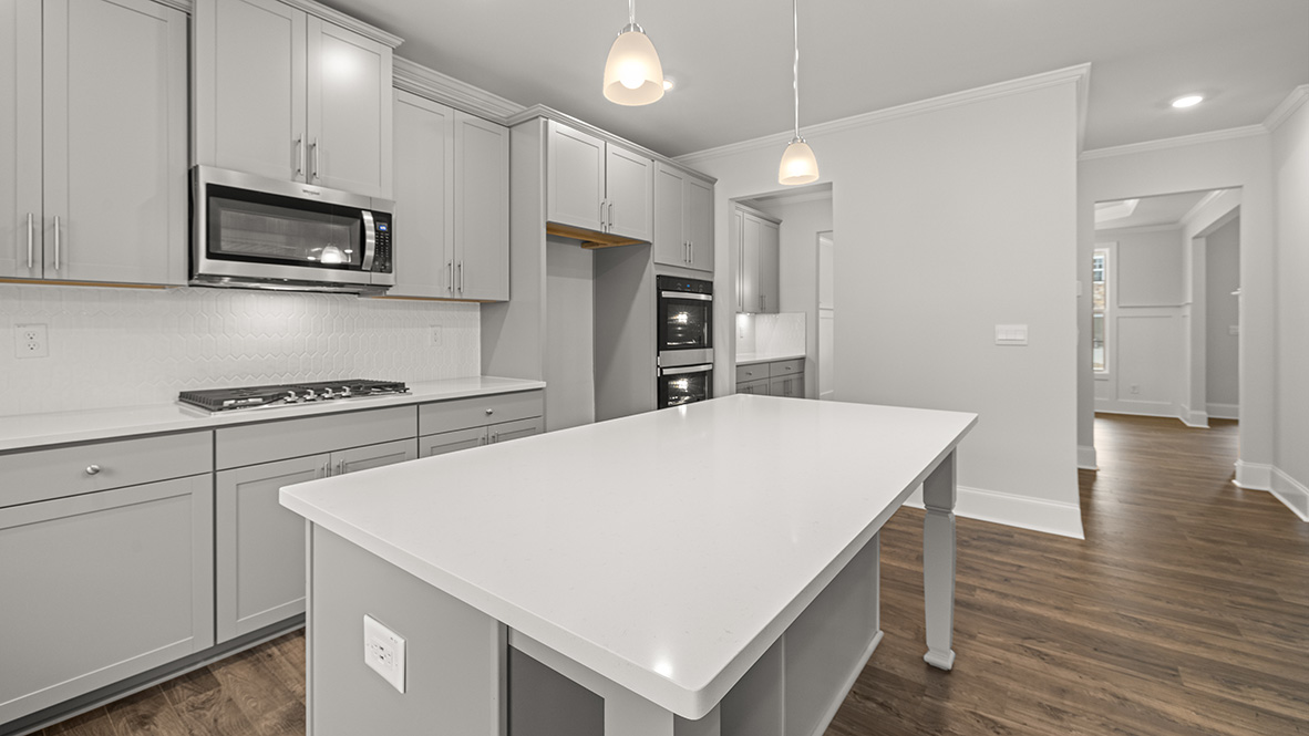 Interior kitchen with center island and light grey cabinets