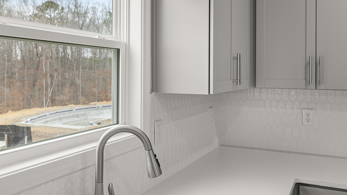 Interior kitchen with center island and light grey cabinets