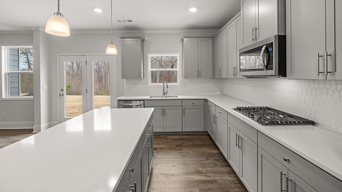 Interior kitchen with center island and light grey cabinets