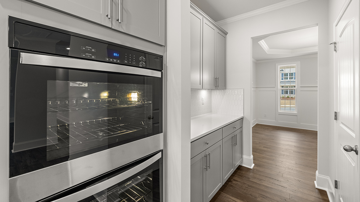 Interior kitchen with center island and light grey cabinets
