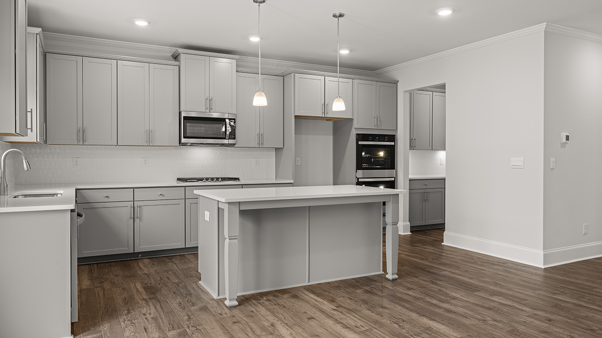 Interior kitchen with center island and light grey cabinets