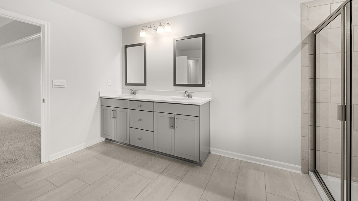 Interior primary bathroom with double sink, shower and bath tub