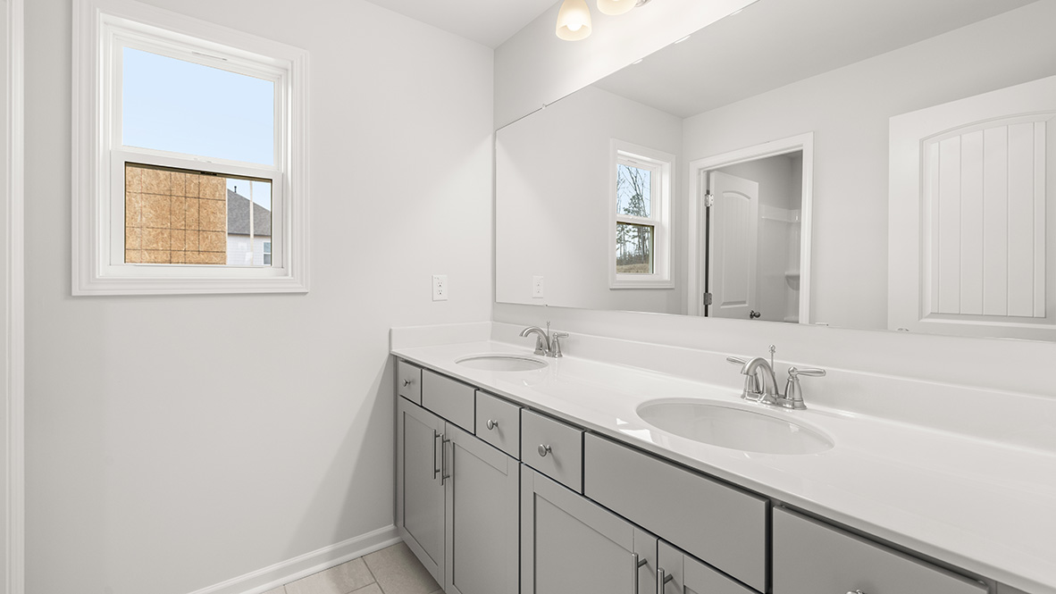 Interior bathroom with double sink and window