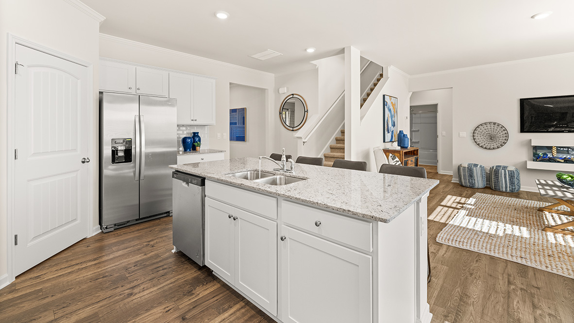 hayden kitchen with large island white cabinets and granite countertops at thompson ridge in dallas georgia
