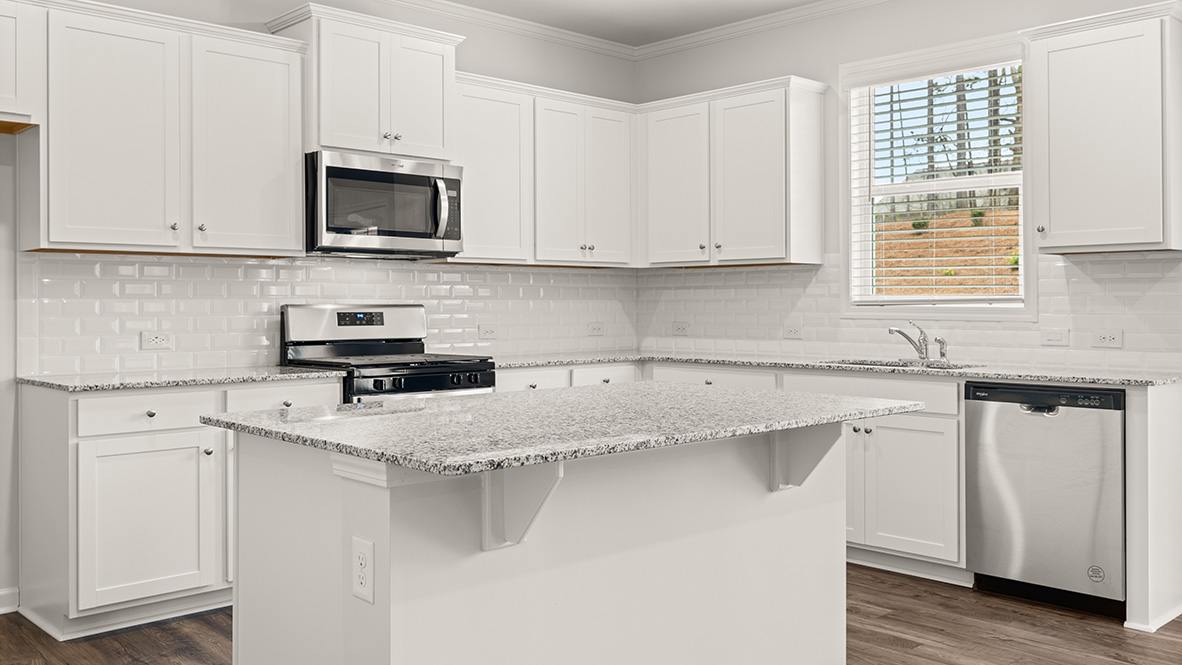 Interior kitchen with center island and white cabinets