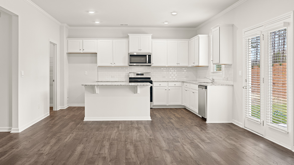 Interior kitchen with center island and white cabinets