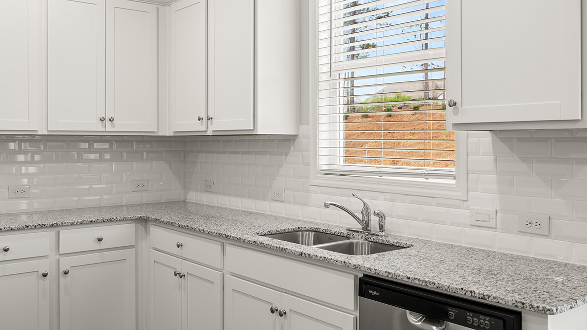 Interior kitchen with center island and white cabinets