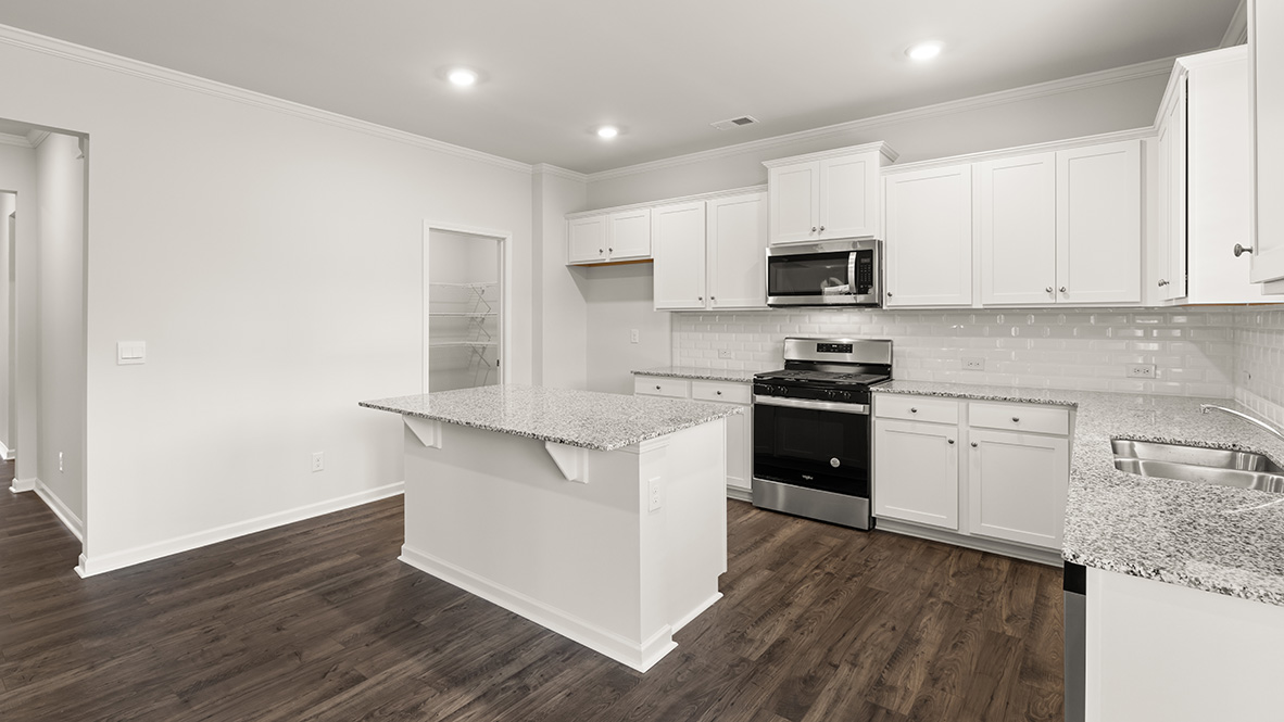 Interior kitchen with center island and white cabinets