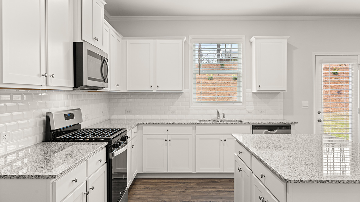 Interior kitchen with center island and white cabinets