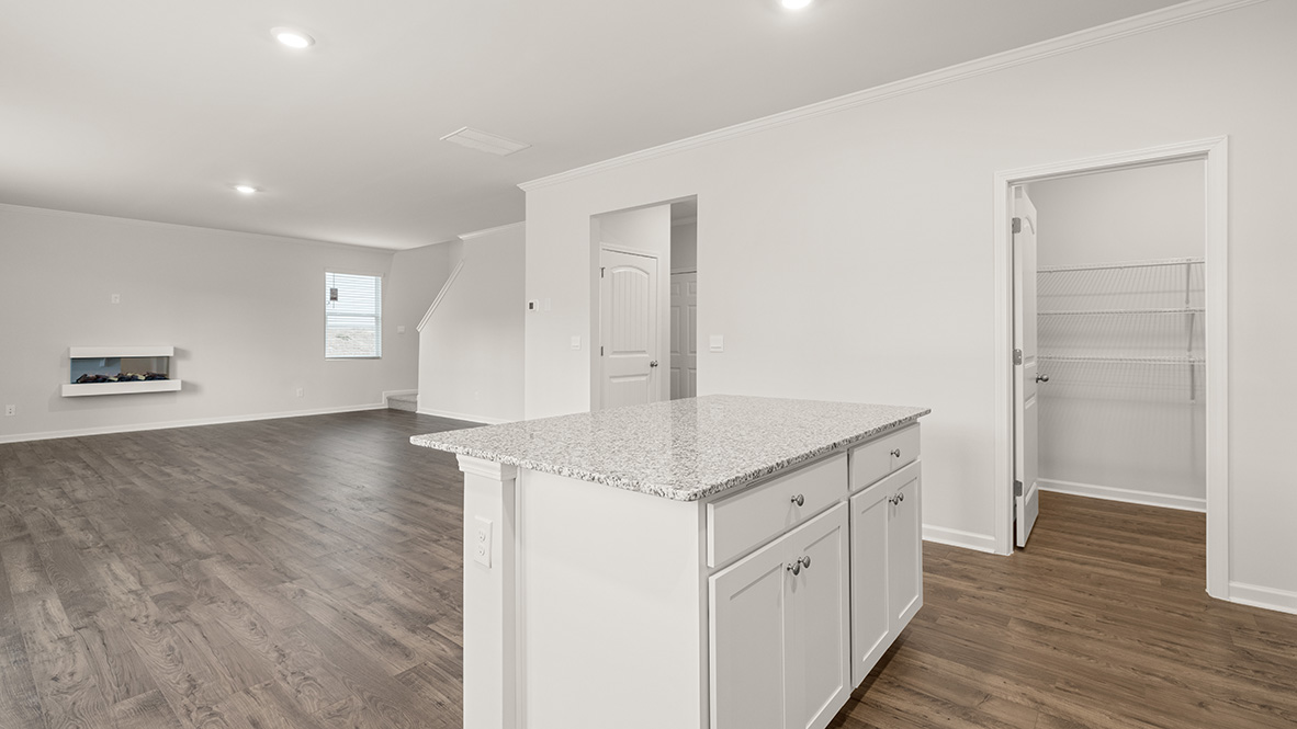 Interior kitchen with center island and white cabinets