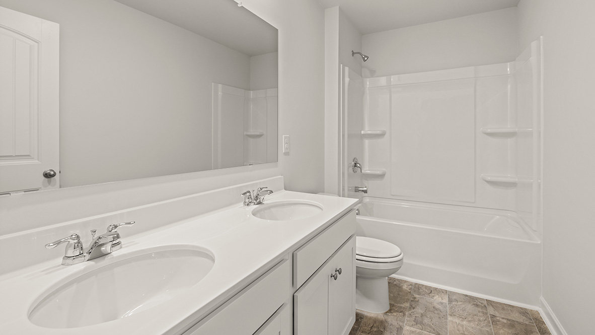 Interior bathroom with double sink and full-sized shower
