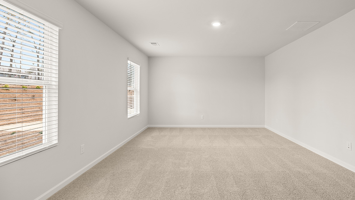 Interior primary bathroom with large windows