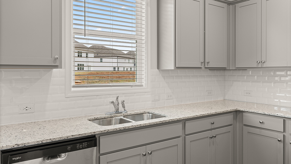 hanover kitchen with grey cabinets and stainless steel appliances at Thompson Ridge