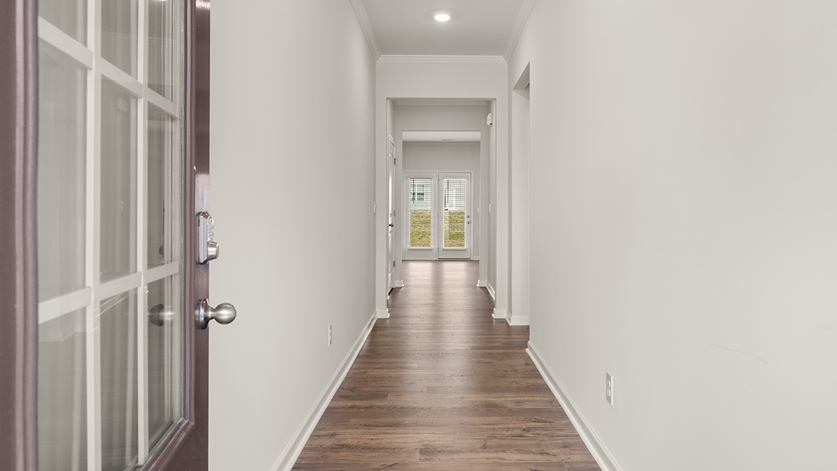 hanover front entryway with long hallway leading toward living room at Thompson Ridge
