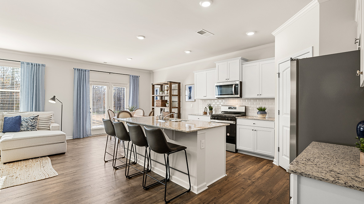 Interior kitchen with center island and white cabinets