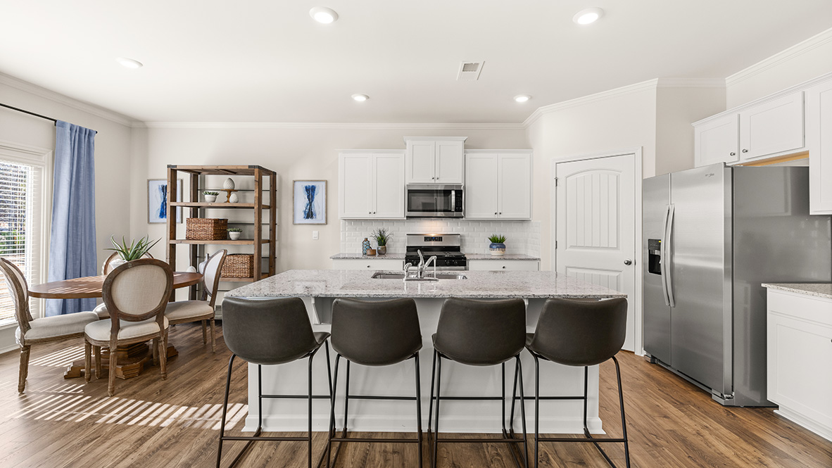 Interior kitchen with center island and white cabinets