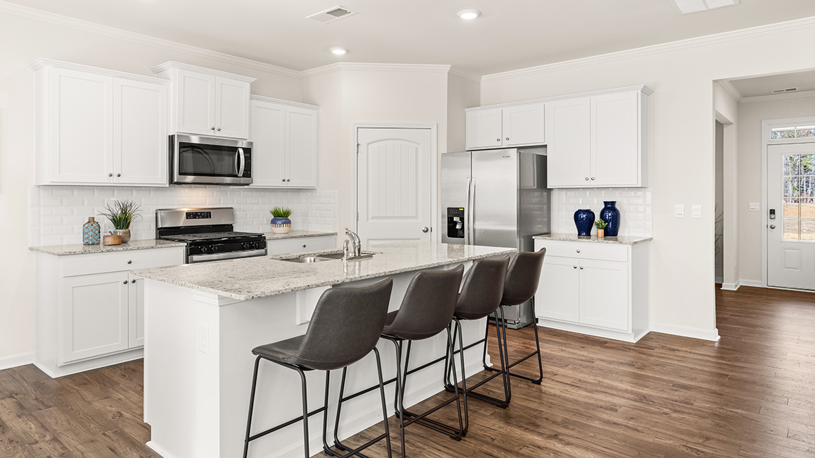Interior kitchen with center island and white cabinets
