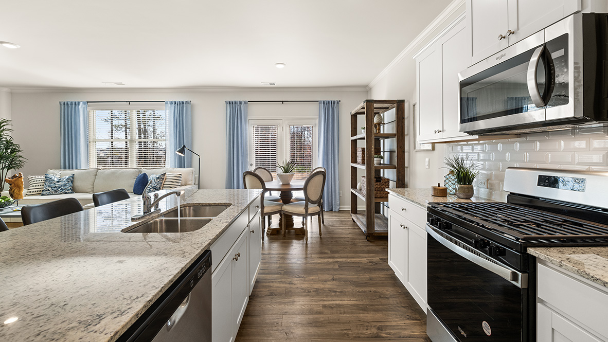 Interior kitchen with center island and white cabinets